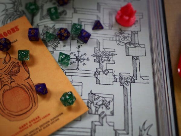 A board game with dice and a map of the dungeon.