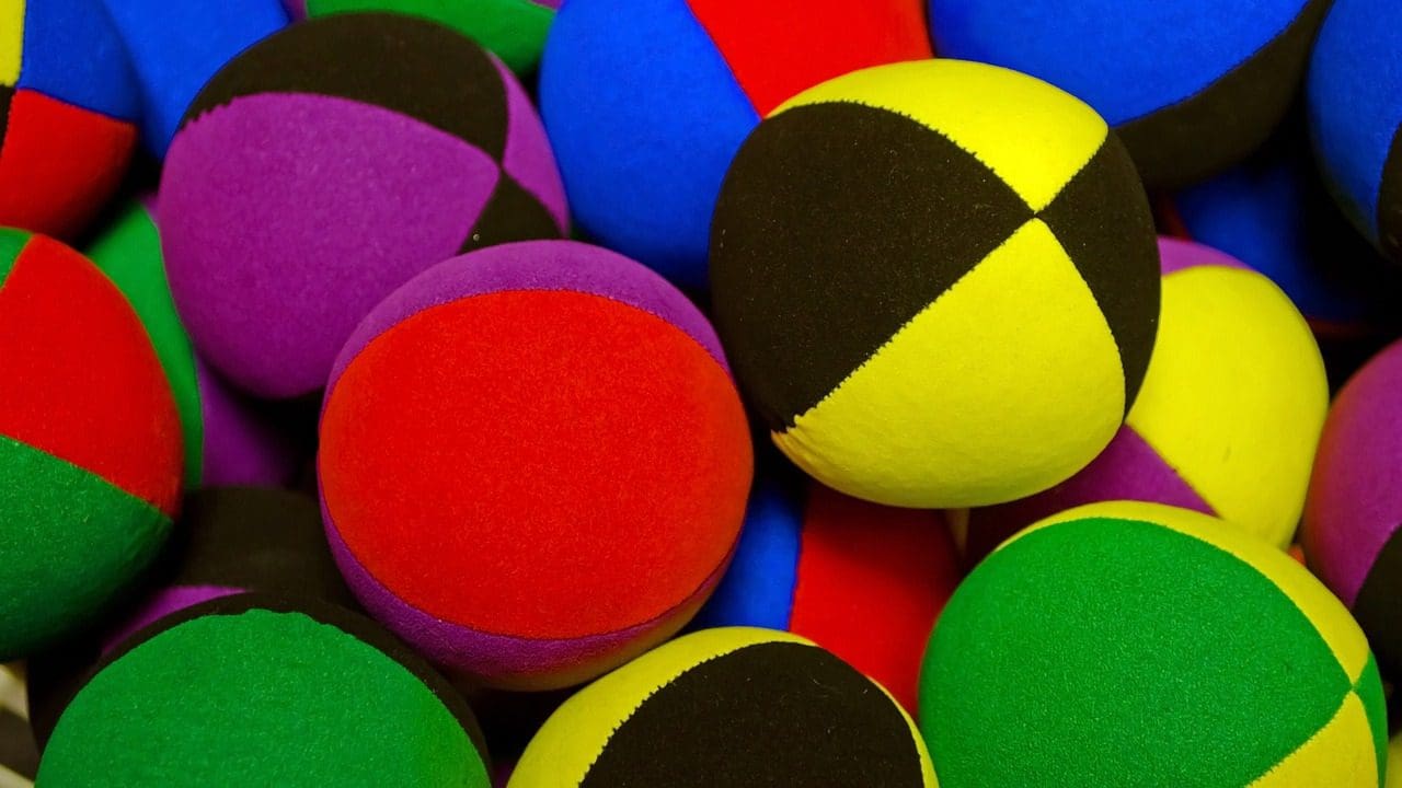 A pile of colorful balls sitting next to each other.