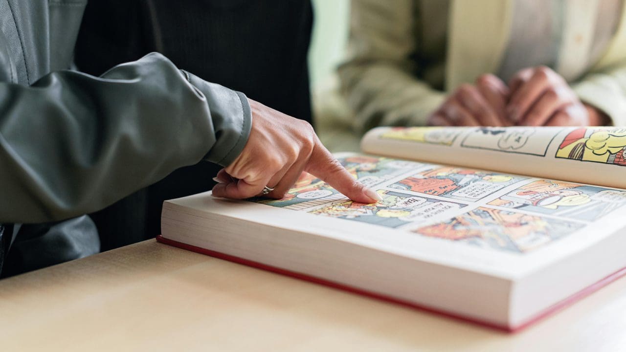 A person is touching the pages of an interactive book.