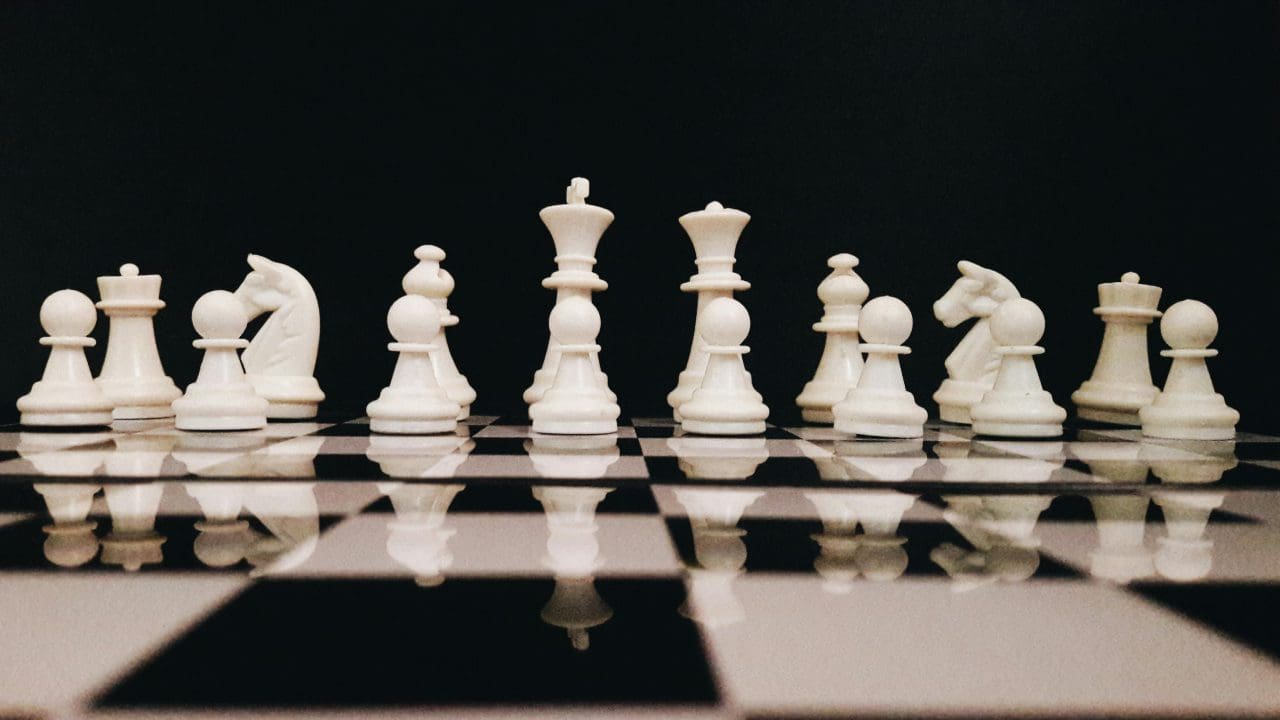 A close up of some chess pieces on the board