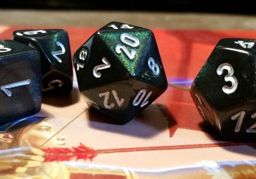 A set of four dice sitting on top of a table.