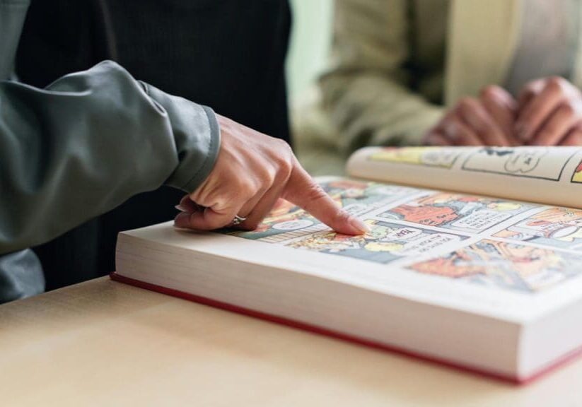 A person is touching the pages of an interactive book.