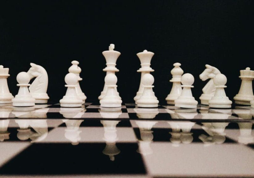 A close up of some chess pieces on the board