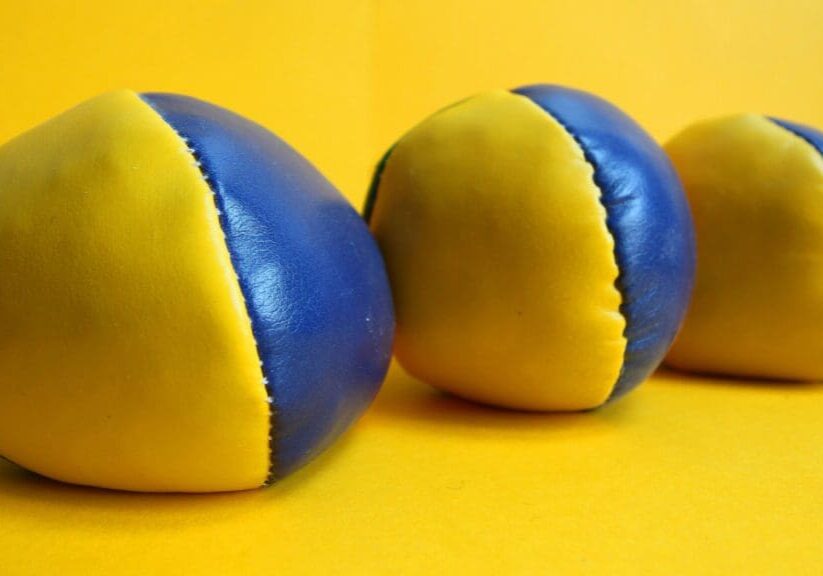 Two blue and yellow balls are on a table.